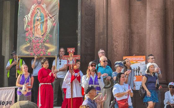 Youth from the Shrine of the Sacred Heart gather at the entrance of the Cathedral of St. Matthew the Apostle in Washington after a procession to observe the World Day of Migrants and Refugees Sept. 28, 2025. (GSR photo/Rhina Guidos)