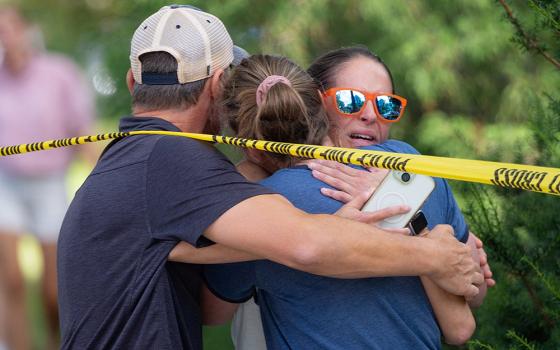 Shooting 1 Families and loved ones reunite following a shooting at Annunciation Church in Minneapolis Aug. 27, 2025. A gunman opened fire with a rifle into the church during Mass for Annunciation School's first week of classes, killing two children and wounding 21 people, most of them children. (OSV News/Reuters/Ben Brewer)