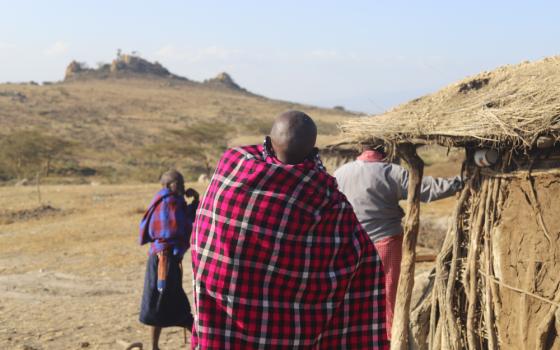A Maasai woman carries her baby outside her hut in the Ngorongoro Conservation Area. Evictions have hit women and children especially hard, disrupting education, health care and family livelihoods. (GSR photo/Doreen Ajiambo)