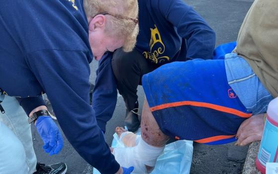 Sr. Mary Meyers bandages the foot of a patient at Project Hope in Wheeling, West Virginia. She works on Pittsburgh's Duquesne University campus during the week and volunteers on weekends, providing health care for those in need. (Courtesy of Mary Meyers)