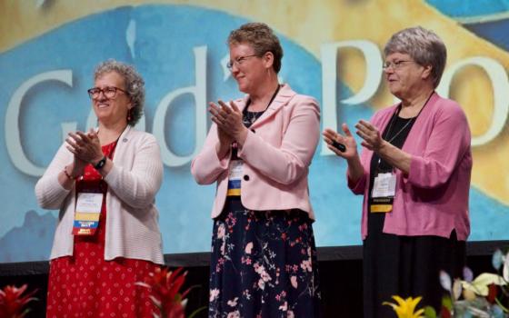 LCWR president-elect Sr. Debra Sciano, left, stands on the LCWR assembly stage with president Sr. Vicky Larson and past president Sr. Kathy Brazda in Atlanta Aug. 15. (GSR photo/Dan Stockman)