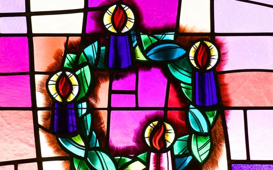 An Advent wreath is depicted in a stained-glass window at Christ the King Church in Commack, New York. (CNS/Gregory A. Shemitz)