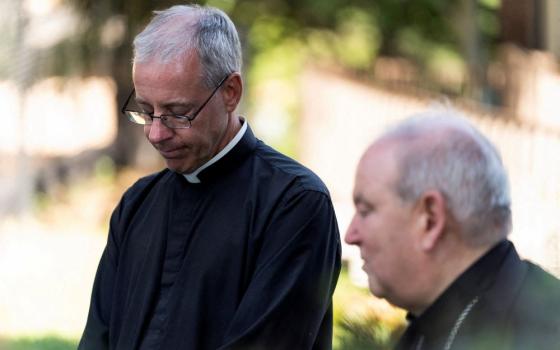 Annunciation Church pastor Fr. Dennis Zehren, left, becomes emotional as he speaks to the media alongside St. Paul and Minneapolis Archbishop Bernard Hebda Aug. 30 about the Aug. 27 shooting at the church. 