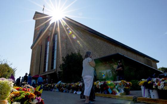 The sun shines over a memorial outside Annunciation Catholic Church during Mass after the Aug. 27 shooting, Sunday, Aug. 31, 2025, in Minneapolis. (AP photo/Ellen Schmidt)
