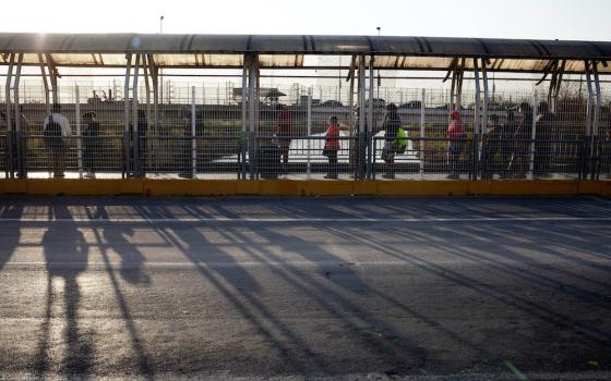 People authorized to cross the U.S.-Mexico border line up on the U.S. side of the McAllen-Hidalgo-Reynosa International Bridge early in the morning of March 22 in McAllen, Texas. (Nuri Vallbona)