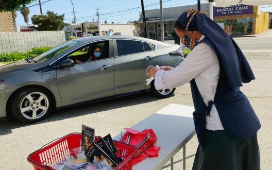 Sr. Mary Jerome Connor prepares individual packages for drivers coming to pick up rosaries during the Daughters of St. Paul's 10-day "pray the rosary to end the pandemic" giveaway in May. (Sr. Rose Pacatte)