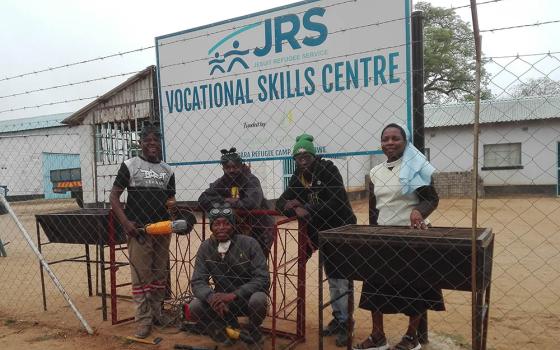 Sr. Mildness Chinake, right, visits welders. Vocational skills training is a key component of empowering refugees at the Tongogara Refugee Camp in Harare, Zimbabwe. (Courtesy of Mildness Chinake)