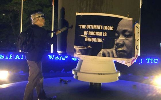 Patrick O'Neill hammers a monument to nuclear war at Kings Bay Naval Submarine Base in April 2018. He was sentenced to 14 months in federal prison after being convicted on several charges. 