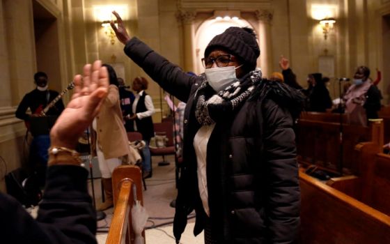 Aline Compaore sings along with the French choir, Chorale Sainte Marie Reine, at the end of Mass at the Church of Notre Dame in New York, on Sunday, March 6. Today, it is largely African Catholics who worship at the church's French service. (AP/Jessie War