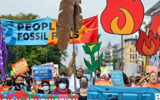 Environmental activists march to the U.S. Capitol during an Oct. 15, 2021, climate change protest in Washington. (CNS/Reuters/Evelyn Hockstein)