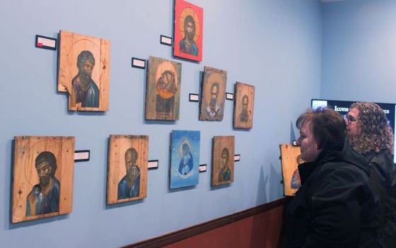 Attendees look at the "Icons on Ammo Boxes Exhibit," part of a fundraising event for Ukraine at Annunciation Byzantine Catholic Church in Homer Glen, Illinois, March 31. The event was sponsored by the parish, Rebuild Ukraine and CNEWA. (CNS/Laura Ieraci)