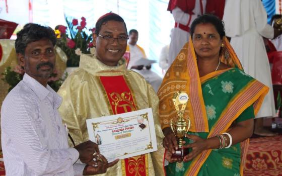 Lalita Beero and her husband receive recognition April 24 from Bishop Sarat Chandra Nayak. (Sujata Jena)