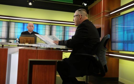 Archbishop José H. Gomez of Los Angeles, president of the U.S. Conference of Catholic Bishops, looks on as Msgr. Jeffrey D. Burrill, USCCB general secretary, reads a message to Pope Francis June 16, 2021. 