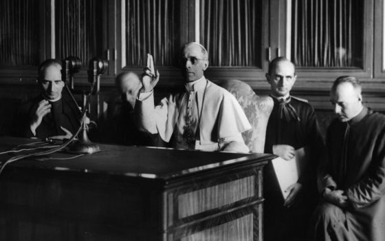 Pope Pius XII gives a blessing at the end of a radio message Sept. 1, 1943. (CNS)