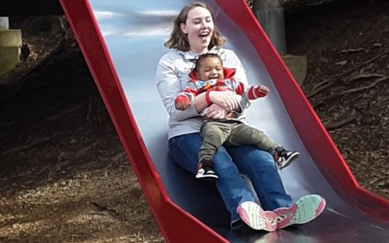 Mary-Teresa Robinette, Change a Heart Franciscan Volunteer Program volunteer, joins a child from Angels' Place in Pittsburgh on the slide in March 2020. (Provided photo)