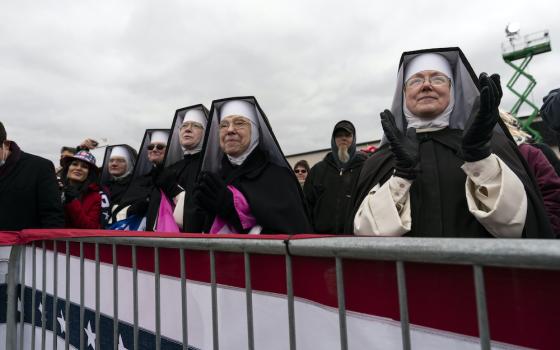 Dominican Sisters of the Immaculate Heart of Mary, based in Hartland, Michigan, and who do not have canonical standing with the Catholic Church, applaud as then President Donald Trump speaks at a campaign rally Oct. 30, 2020. (AP/Alex Brandon)