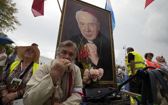 Catholic faithful attend the beatification ceremony of Polish Cardinal Stefan Wyszynski and Mother Elzbieta Roza Czacka in front of the church of Providence in Warsaw, Poland, Sunday, Sept. 12, 2021. (AP/Czarek Sokolowski)