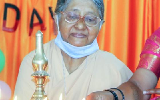 Sr. Adele Korah lights a lamp at the 2021 International Women's Day celebrations held in Bengaluru, India, for the families and relatives of prisoners. (Courtesy of Adele Korah)