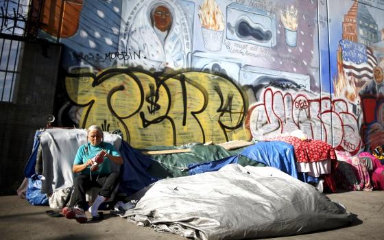 A woman sits outside her tent on Skid Row in downtown Los Angeles in 2015. (CNS/Reuters/Lucy Nicholson)