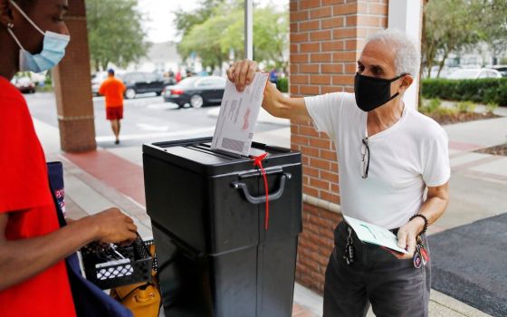 A man in Orlando, Florida, casts his mail-in ballot Oct. 19, as early voting begins ahead of the November 3 election. (CNS/Reuters/Octavio Jones)