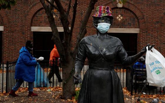 People near a statue of Ella Fitzgerald in Yonkers, New York, Nov. 17 (CNS/Reuters/Shannon Stapleton)