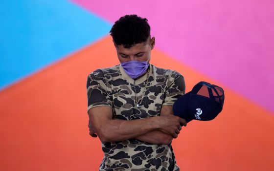 A migrant prays during a Mass at Posada Belen migrant shelter in Saltillo, Mexico, Nov. 10, 2020. (CNS/Reuters/Daniel Becerril)