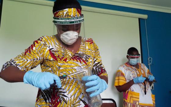 Workers prepare protective face shields from recycled plastics at the Zaidi Recyclers workshop in Dar es Salaam, Tanzania, May 21, 2020. (CNS/Reuters)