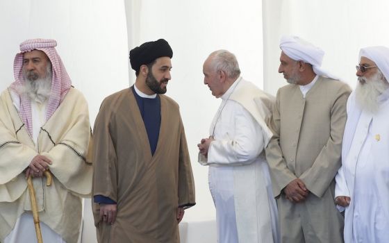 Pope Francis talks with a religious leader during an interreligious meeting on the plain of Ur near Nasiriyah, Iraq, March 6, 2021. (CNS/Paul Haring)