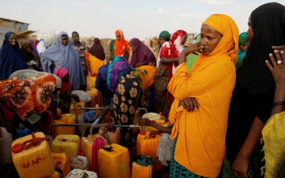 Displaced Somali women from drought hit areas wait to fill their containers at a water filling station April 3, 2017, at a camp in Dollow, Somalia. (CNS/Reuters/Zohra Bensemra)