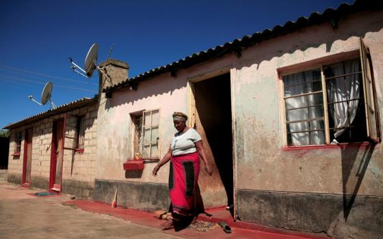 A woman walks out of her family home in Harare, Zimbabwe, on May 9 during the COVID-19 pandemic. (CNS/Reuters/Philimon Bulawayo) 