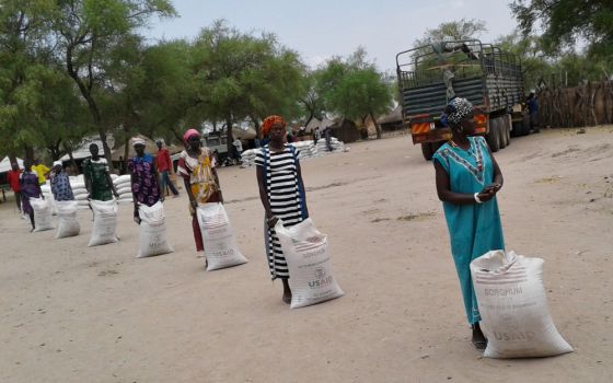 Participants in a U.S. Agency for International Development food security program practice social distancing while waiting to receive food rations at a food-for-assets distribution in Duk, South Sudan, on April 2. (Courtesy of Catholic Relief Services)