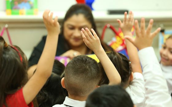 Cristina Escobedo, seen in the background, teaches students at St. Mary Magdalen School in San Antonio. (Jesus Ramirez)