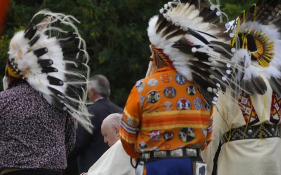 Pope Francis prays with Indigenous people in a cemetery at the former residential school in Maskwacis, near Edmonton, Canada, July 25. (AP/Gregorio Borgia)