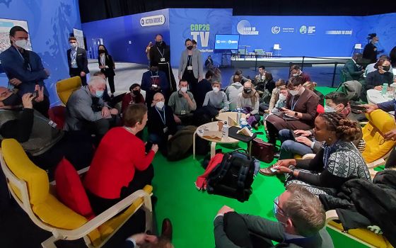 Catholics working on climate issues gather Nov. 4 between events at COP26 in Glasgow, Scotland. (EarthBeat photo/Brian Roewe)