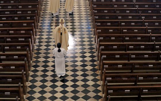 Archbishop Gregory Aymond conducts the procession to lead a live streamed Easter Mass in St. Louis Cathedral in New Orleans April 12, 2020. The New Orleans Archdiocese declined to discuss the federal investigation. (AP file photo/Gerald Herbert)