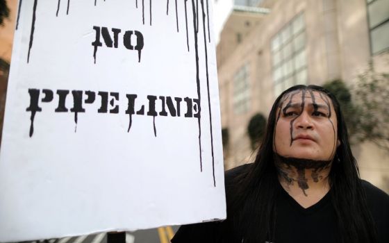 Pipeline projects spark protest not only at rural construction sites, but also among urban activists like this demonstrator in Los Angeles in 2017. (CNS photo/Lucy Nicholson, Reuters)