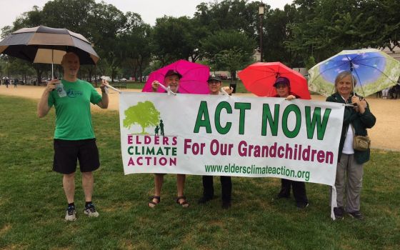 David Mog, second from left, stands with Elders Climate Action co-chair Leslie Wharton, third from left, and other activists represent Elders Climate Action banner at an event in Washington, D.C. July 20, 2018. (Provided photo)