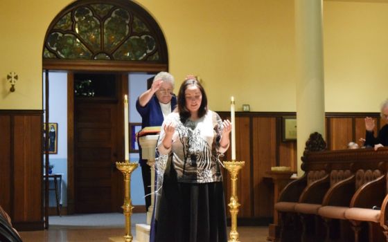 Sr. Esther Fangman, prioress of the Benedictine Sisters of Mount St. Scholastica of Atchison, Kansas, blesses Emily Bauer, 26, as she makes her vows as a canonical novice with the community Dec. 7, 2019.