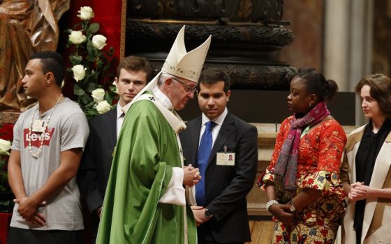 Pope Francis walks to his seat after greeting synod observers during the closing Mass of the Synod of Bishops on young people, the faith and vocational discernment in St. Peter's Basilica at the Vatican Oct. 28, 2018. (CNS/Paul Haring)