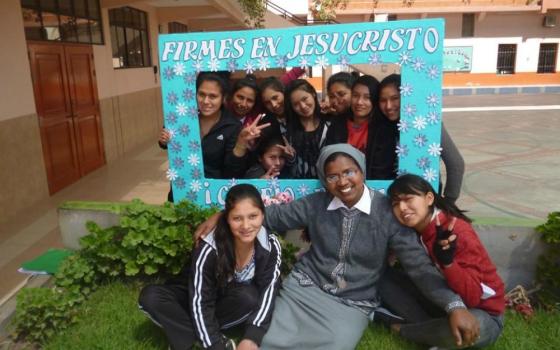 Franciscan Missionary of Mary Sr. Marian Champika Hanzege poses for a photo with girls at Immaculate College in Abancay, Peru, in 2011. (Provided photo)