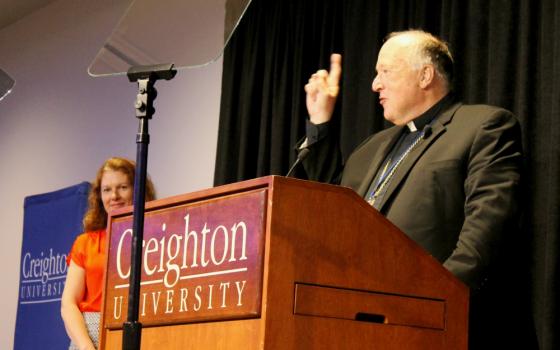 San Diego Bishop Robert McElroy counts down before he leads a sing-along of "God Bless America" during the inaugural "Laudato Si' and the U.S. Catholic Church" conference series June 27 at Creighton University in Omaha, Nebraska. (NCR photo/Brian Roewe)