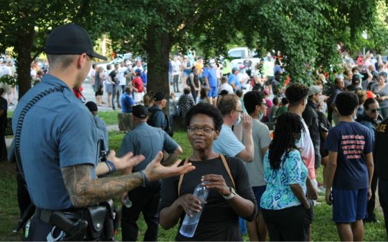 Justine Kenner speaks with a police officer ahead of a "Unity March" in Kansas City, Missouri, June 3. (NCR photo/Brian Roewe)