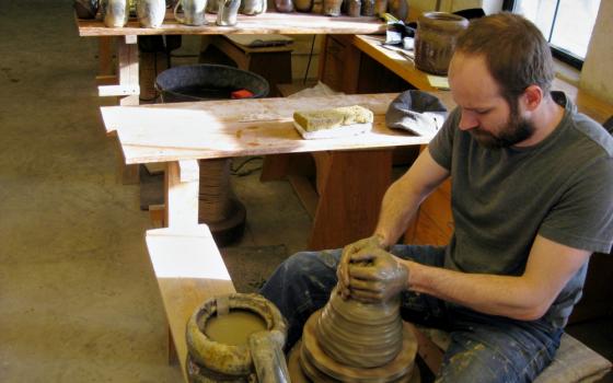 Apprentice Brandon Russell works at the potter's wheel in the St. John's Pottery studio in Collegeville, Minnesota. (Zoe Ryan)