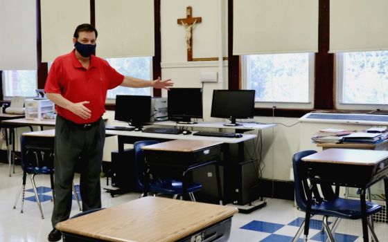 Principal Robert Chevrier shows off a socially distanced sixth-grade classroom at St. Joseph School in Medford, Massachusetts, July 28. Soon the desks will all have plastic dividers as well. (Alexander Thompson)