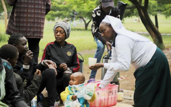 Sr. Caroline Ngatia shares breakfast with the street families in Nairobi, Kenya. The nun has been feeding the underprivileged children for years and, as a result, the kids simply call her "mum." (Doreen Ajiambo)