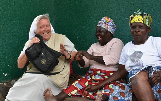 Sr. Judith Bozek, a Missionary Sister of the Holy Family, shares a light moment with Esnart Kangwa (in pink shirt), one of the elderly residents at the Cheshire Divine Providence Home, located in a large slum just southwest of Lusaka, Zambia.