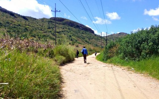 People walk along a road in Malawi April 13. (Wikimedia Commons/Matt Khofi)