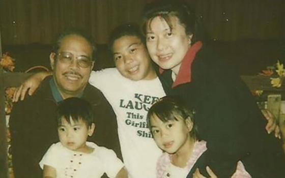 My family in 2006. From left: Osmundo Evangelista Jr. (my papa), holding Jenalyn Evangelista (my baby sister); Joseph Evangelista (my older brother); and Maria Ignacio (my mom), holding me. (Courtesy of Jaesen Evangelista)