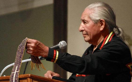 At a 2013 event at Le Moyne College called "Listening to the Wampum," Oren Lyons holds the Jesuit Belt, or the Remembrance Belt, which depicts the history of contact between French Jesuits and the Onondaga in the 1650s. (Michael Davis)