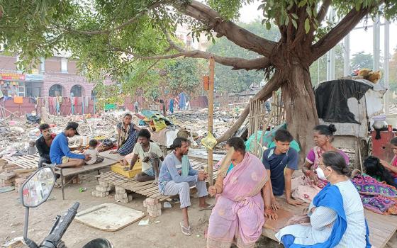 People sit at the site of their demolished homes Oct. 9 in Malaai Pakkdi, a settlement in Kankarbagh, Patna city, in Bihar state, in India. (Courtesy of Dorothy Fernandes)